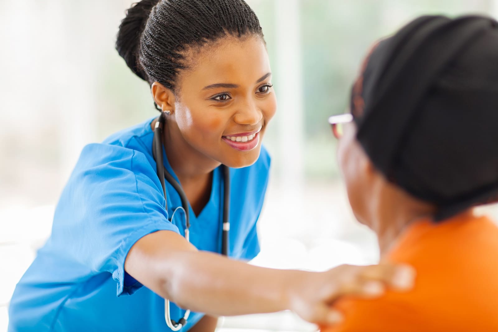An ABC caregiver examining a client at home